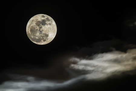 Peaceful background, night sky with full moon, beautiful cloudy.の写真素材