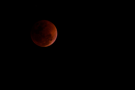 Total lunar eclipse, beautiful blood moon on dark night, Thailand.の写真素材