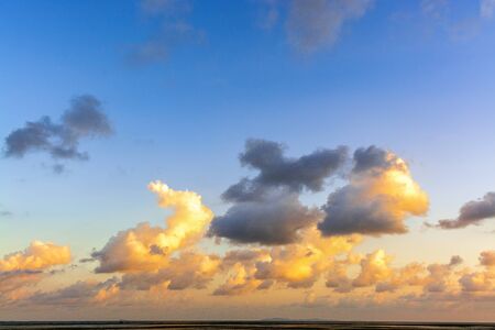 Beautiful Sunset and blue sky filled with orange clouds over the big lake at Thale Noi Waterfowl Reserve nonihunting area, the famous for its attractions in Thailand.の写真素材