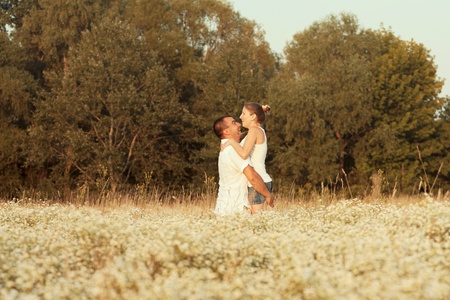 Happy couple enjoying life in the field, playing outdoorsの写真素材