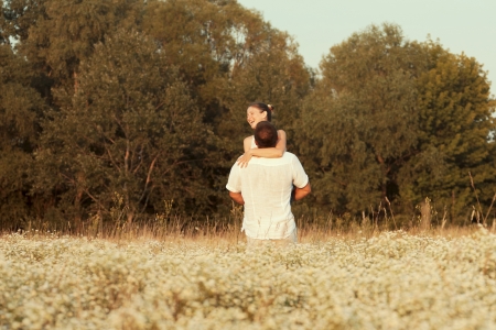 Happy couple enjoying life in the field, playing outdoorsの写真素材