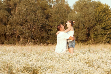 Happy couple enjoying life in the field, playing outdoorsの写真素材