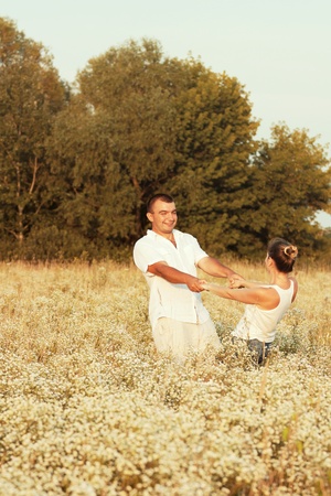 Happy couple enjoying life in the field, playing outdoorsの写真素材