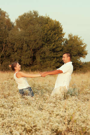 Happy couple enjoying life in the field, playing outdoorsの写真素材