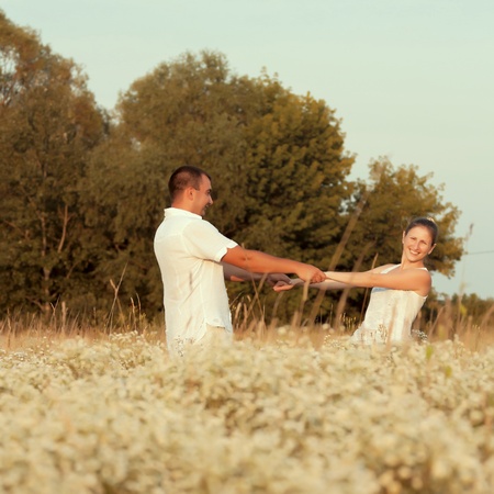 Happy couple enjoying life in the field, playing outdoorsの写真素材