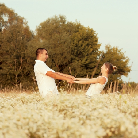 Happy couple enjoying life in the field, playing outdoorsの写真素材
