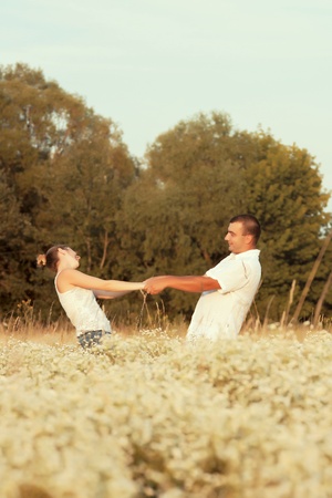 Happy couple enjoying life in the field, playing outdoorsの写真素材