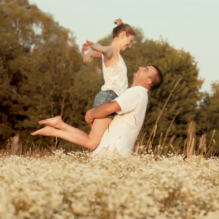 Happy couple enjoying life in the field, playing outdoorsの写真素材