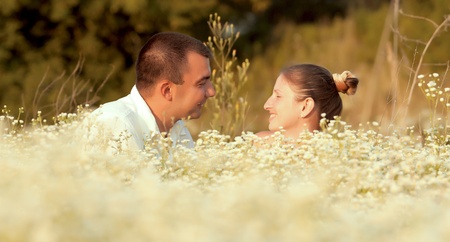 Happy couple enjoying life in the field, playing outdoorsの写真素材