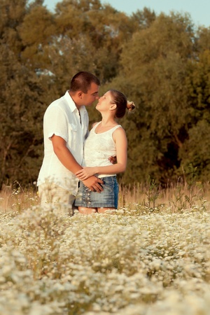 Happy couple enjoying life in the field, playing outdoorsの写真素材