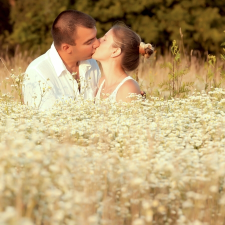 Happy couple enjoying life in the field, playing outdoorsの写真素材