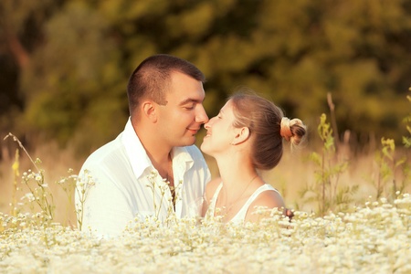 Happy couple enjoying life in the field, playing outdoorsの写真素材