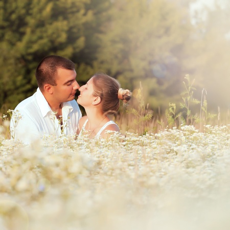 Happy couple enjoying life in the field, playing outdoorsの写真素材