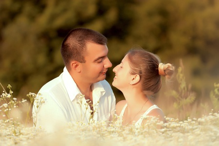 Happy couple enjoying life in the field, playing outdoorsの写真素材