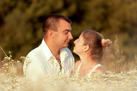Happy couple enjoying life in the field, playing outdoorsの写真素材