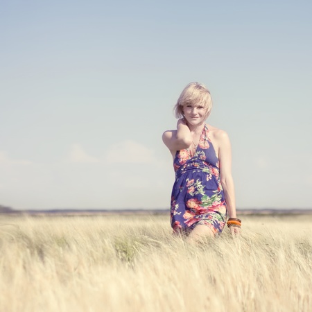 Beautiful blonde girl in a wheat fieldの写真素材