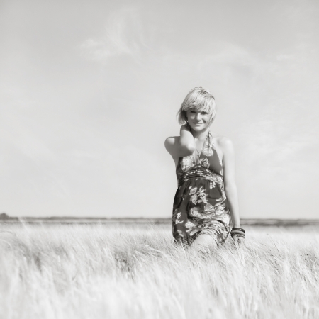 Beautiful blonde girl in a wheat fieldの写真素材