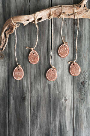 Easter cookies on a rope on the background of the old board