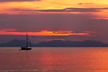 Beautiful colorful sunset and boat in Thailandの写真素材