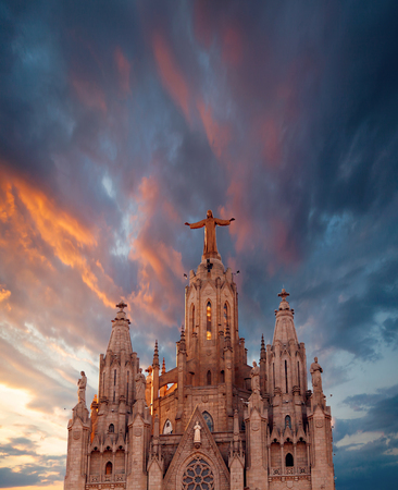 The Sagrat Cor church atop the mountain. Church atop the mountain against the background a beautiful sunset sky. Barcelona, Spain.の写真素材