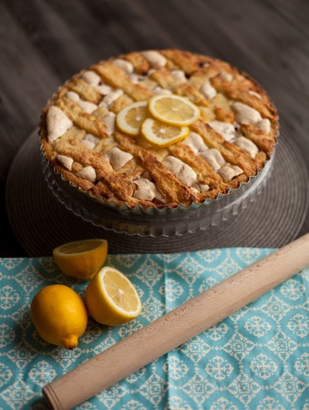 Homemade pie covered with strawberries and rhubarb and meringue. Home baking in vintage style. Fruit pie.の写真素材