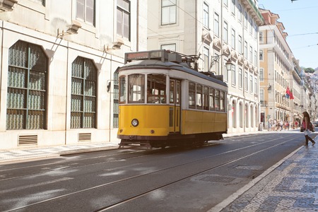 Traditional yellow trams on a street in Lisbon, Portugalの写真素材