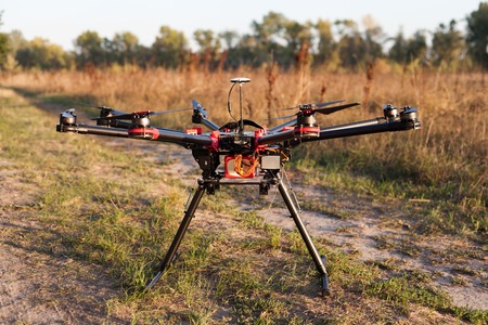 Drone on a background of a beautiful sunset. UAV in flight. Quadrocopters on radio.の写真素材