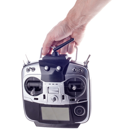 Remote control radio model in the hands of man on a white background.