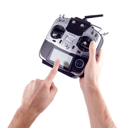 Remote control radio model in the hands of man on a white background.の写真素材