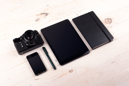 Outfit of traveler, photographer, student, teenager, young woman or guy. Different objects for planning vacation, trip or business trip on a white wooden background.の写真素材