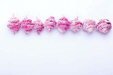 Delicious homemade sweet pink marshmallow with blackcurrant, dusted with icing sugar on a white background. Top view.の写真素材