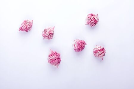Delicious homemade sweet pink marshmallow with blackcurrant, dusted with icing sugar on a white background. Top view.の写真素材