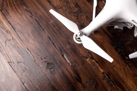 Drone on the old wooden background. Aerial shooting concept. Copter concept of thinking about the objects of flight. Before flight training. Top view. Outfit before the flight.の写真素材