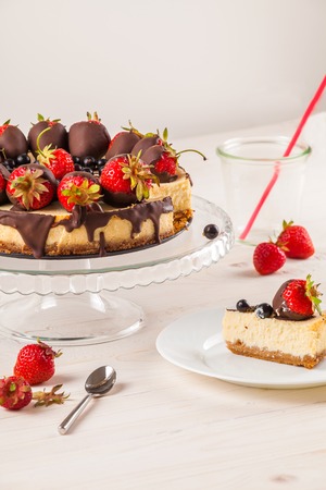 Delicious cheesecake with berries on table close up. White wooden background. Tasty dietary pastries. Natural product. Light dessert.の写真素材