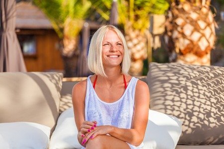 Amazing sensual woman siting on deckchair, enjoying summer holidaysの写真素材