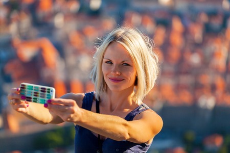 Female traveler make a selfie photo against the background of the old city of Dubrovnik from the mountainの写真素材