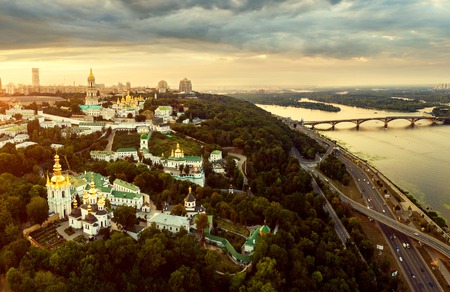 Panoramic view of Kiev Pechersk Lavra at sunset. Aerial view. General view of the city and the Dnipro river and beautiful sunset sky.の写真素材