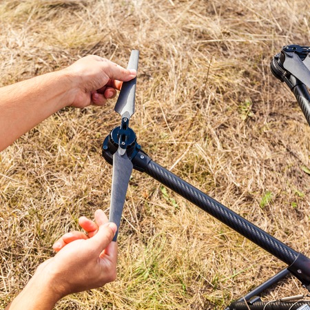 The process of setting up a copter before flight. The man makes all the necessary adjustments before...