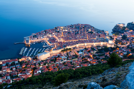 Lovely panoramic view of the old walled city of Dubrovnik with bird's eye view at night. City backlit. Croatiaの写真素材