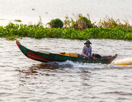 Tonle Sap Lake Siem Reap, Cambodia - OCTOBER 13, 2012: Asian woman floating on a motorboat. The life of the local residentsのeditorial素材