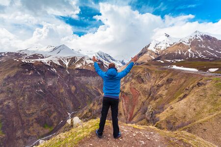 Man standing in the background of mountains, Georgia.
