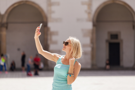 Female traveler on the background of Arcades in Wawel Castle in Cracow.の写真素材