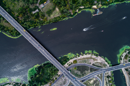 Aerial view of the bridge and the road over the Dnepr River over a green island in the middle of the riverの写真素材