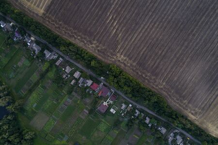Panoramic view of the valley with green fresh fields and village. Aerial view of countrysideの写真素材