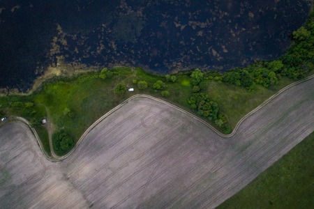 Countryside view with a beautiful lake at sunset. Aerial view. From aboveの写真素材