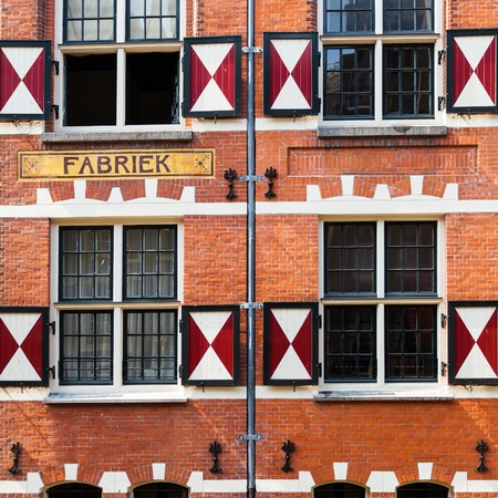 Fragment of colorful typical dutch building near Saint Nicholas Church.