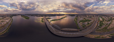 Large aerial view panorama of the city of Kiev with a view of the Darnytsky Bridge in sunsetの写真素材