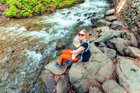 Moms hiking trip with a baby in a backpack.の写真素材