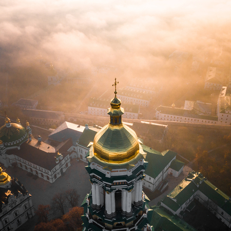 Aerial view of Kiev Pechersk Lavra at dawn and the city covered with thick fogの写真素材