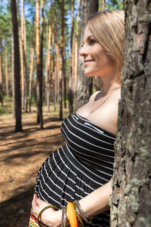 Pregnant woman in the forestの写真素材